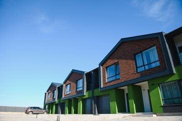 A row of residential townhomes or townhouses in suburb. Concept of real estate development, the housing market, and homeownership
