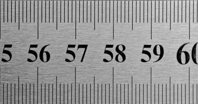 Metal Ruler Close-Up. Video featuring a detailed view of a sleek metal ruler with precise millimeter markings, captured in high clarity.