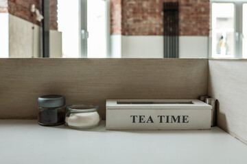 Tea station setup with a wooden box labeled 
