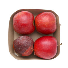 Spoiled apple and good ones in box isolated on white, top view
