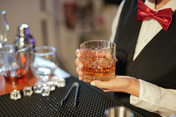  Professional female bartender preparing alcoholic drinks in a bar