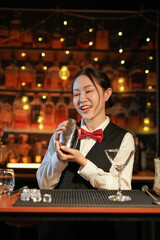 Professional female bartender preparing alcoholic drinks in a bar