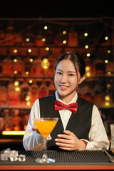  Professional female bartender preparing alcoholic drinks in a bar