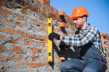 Construction worker in uniform and safety equipment have job on building