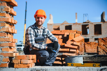 Construction worker in uniform and safety equipment have job on building