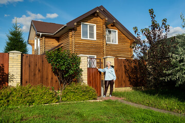 A Woman Standing at the Entrance of Her Home in a Beautiful and Picturesque Neighborhood