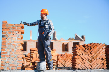 Construction worker in uniform and safety equipment have job on building