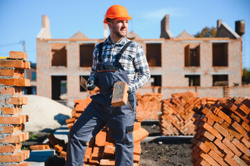 Construction worker in uniform and safety equipment have job on building