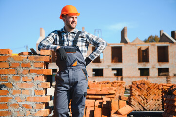 Construction worker in uniform and safety equipment have job on building