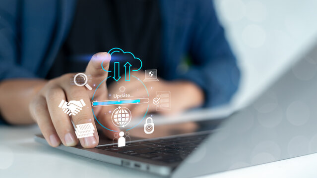 Hand touching laptop with virtual icons of cloud computing, data synchronization, software update, and cybersecurity, representing digital technology and online data management.