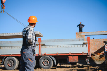 male engineer construction checking and maintenance of parts of construction crane at construction...