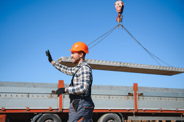 Portrait of a builder in the process of working on a construction site outdoors