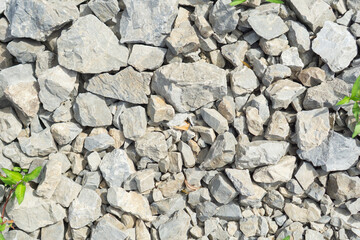 Mixed light-colored river stones and pebbles creating a natural texture, suitable for landscaping companies, construction material suppliers, and outdoor design firms