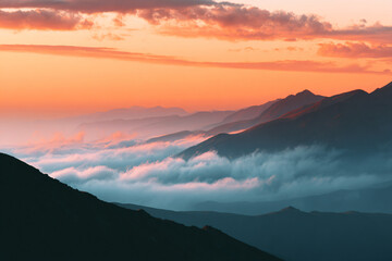 a mountain range with a sunset in the background