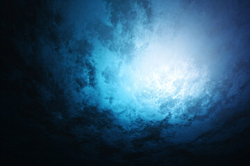 a blue sky with a light shining through it