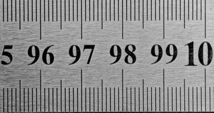 Metal Ruler Close-Up. Video featuring a detailed view of a sleek metal ruler with precise millimeter markings, captured in high clarity.