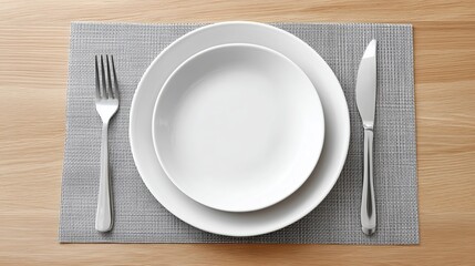 Elegant dining setup with empty plate and cutlery on gray placemat