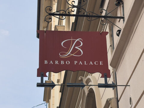 Ljubljana, Slovenia - July 06, 2025: Barbo Palace sign displayed prominently on a historic building, showcasing elegant design and branding in a charming urban setting with clear blue sky