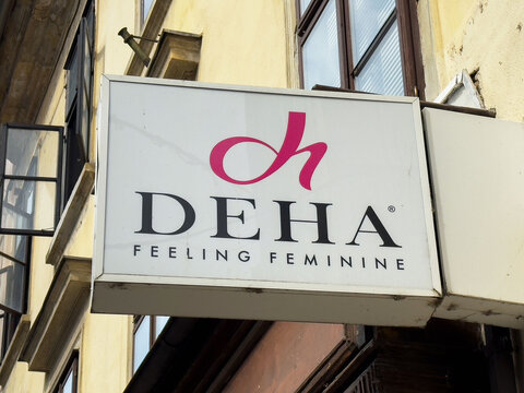 Ljubljana, Slovenia - July 06, 2025: DEHA brand sign showcasing feminine fashion identity on a storefront, emphasizing style and elegance in urban environment with vibrant colors