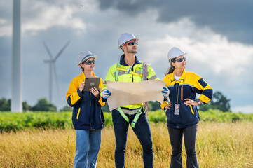 Team of Engineers Planning Project for Renewable Energy Professional Team Inspecting Wind Turbines...