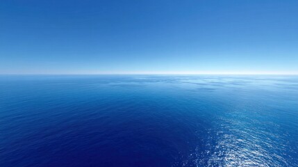 Obraz premium Vast expanse of deep blue ocean under a clear sky
