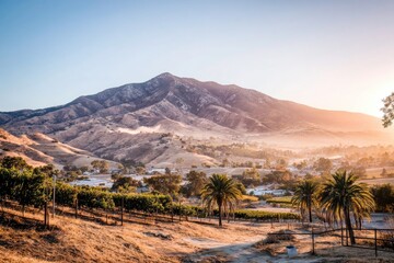 Sunrise over a valley with a mountain backdrop