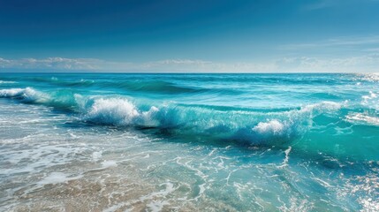 Tranquil turquoise waves lapping a sandy beach under a vibrant blue sky