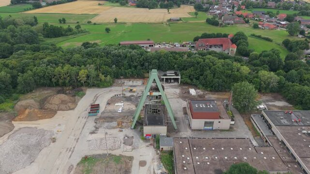 Flug zu einem einzelnen F&ouml;rderturm einer zur&uuml;ckgebauten Zeche im Ruhrgebiet bei wolkigen Himmel im Hochsommer