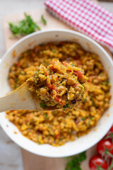 Chickpea curry with rice and vegetables fresh and homemade cooked in a frying pan on decorated background