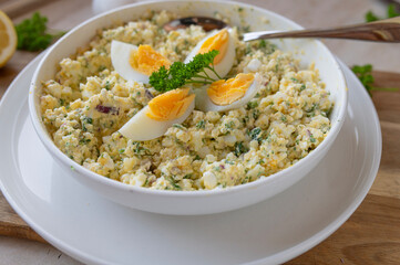 High protein and healthy egg salad with cottage cheese, boiled eggs, and herbs in a bowl