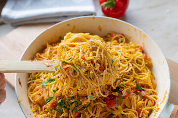 Pan Fried noodles with eggs and vegetables in a frying pan fresh and homemade cooked, 