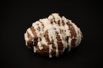 Profiteroles with coconut cream on a black background.