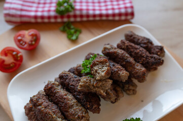 Delicious mititei or rumanian cevapcici on a plate fresh and homemade cooked