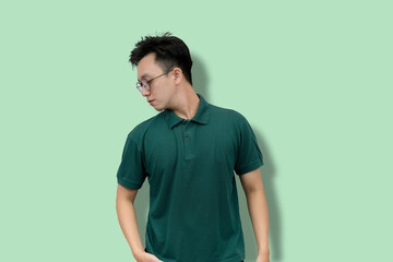 Casual Portrait of a Young Man Wearing Glasses in Green Polo Shirt