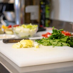 Active kitchen prep scene showing raw ingredients and cooking steps with natural light and shallow depth of field