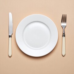 White Plate with Knife and Fork on Beige Background