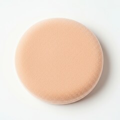 Soft, circular cosmetic sponge in a neutral tone, commonly used for applying foundation or powder in beauty and skincare routines.