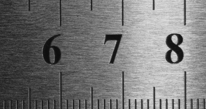 Metal Ruler Close-Up. Video featuring a detailed view of a sleek metal ruler with precise millimeter markings, captured in high clarity.