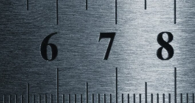 Metal Ruler Close-Up. Video featuring a detailed view of a sleek metal ruler with precise millimeter markings, captured in high clarity.