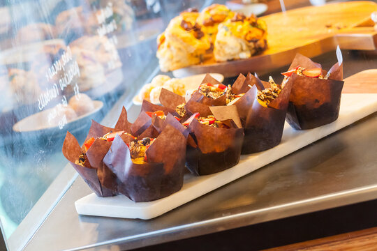 A tray of baked muffins in a display case