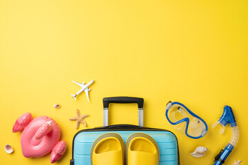 Travel essentials including luggage, toys, flip-flops, and snorkeling gear displayed on sunny...