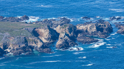 Aerial view of rugged coastline and ocean cliffs along Highway 1 near Soberanes Canyon in Garrapata...