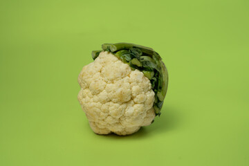 Fresh Cauliflower Head on Vibrant Green Background