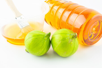 Fresh tung fruit and tung oil on white background