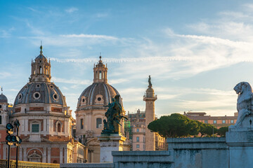 Domes of Church of the Most Holy Name of Mary at the Trajan Forum and Santa Maria di Loreto in Rome, Italy with Trajan's Column at sunrise. Italian architecture. Travel and touristic landmark 