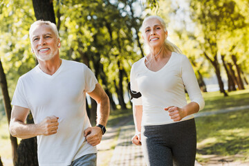 Senior couple, exercise and happy outdoor for run, workout and training for fitness. Old man and...