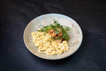 Gourmet scrambled eggs with shrimp and avocado