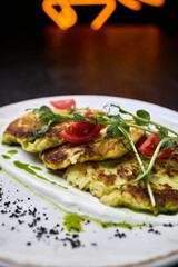 Zucchini fritters with fresh tomato and herbs