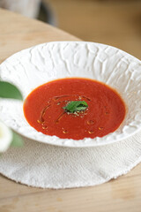 Portion of spanish gazpacho tomato soup on table