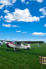 airplane on the green field. blue cloudy sky